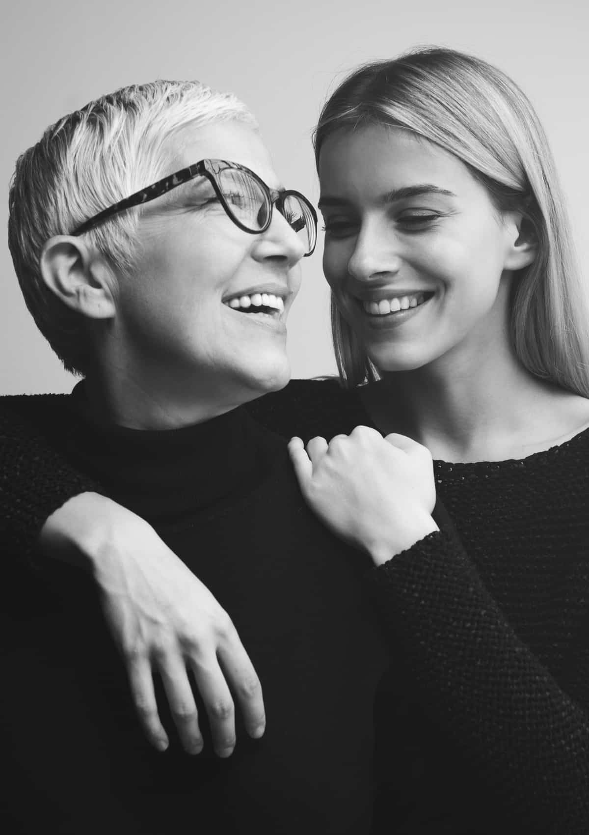 a woman wearing glasses posing for the camera