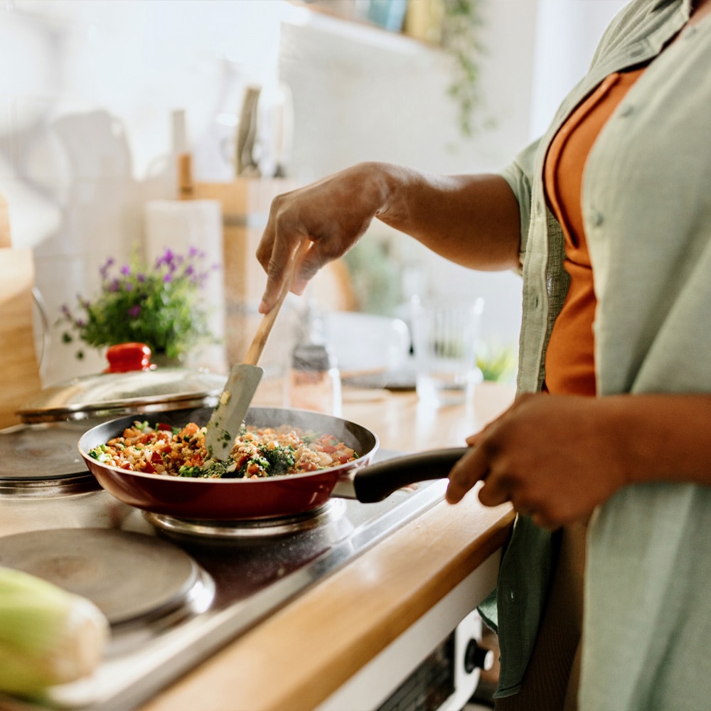 a man cooking in a kitchen preparing food